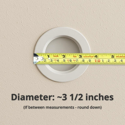 Recessed ceiling light measured with a tape measure showing an example diameter of about 3 1/2 inches, with guidance to round down if between measurements.